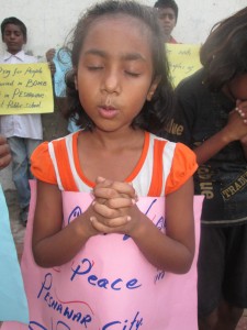 A girl prays for peace in Pakistan.
